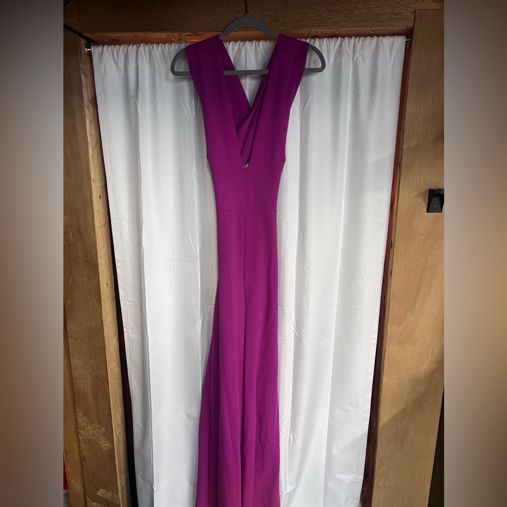Hot pink jumpsuit, stretchy, open crossed back. Very flattering